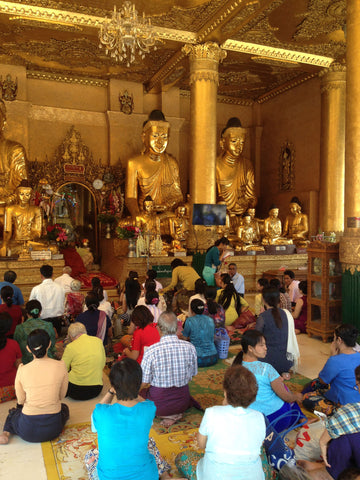 Burmese people praying in Buddhist temple Yangon