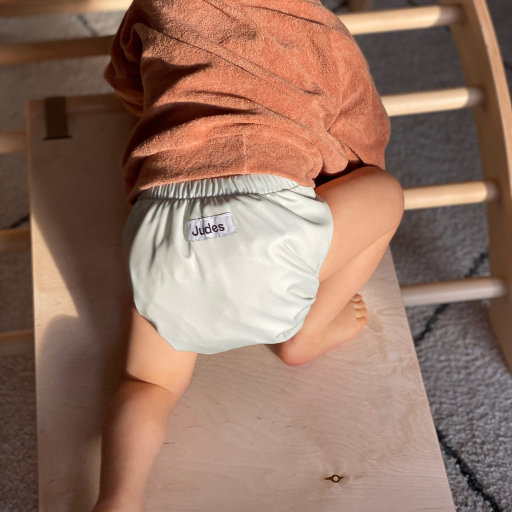 Judes baby climbing in cloth diaper