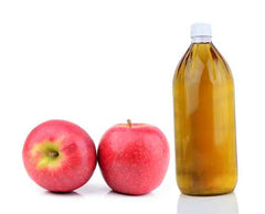 Apples next to apple cider vinegar