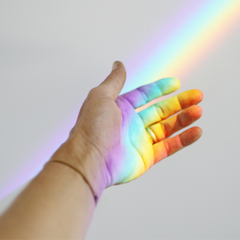 Hand with rainbow shining on it