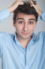 Man grabbing his hair stressed out