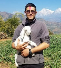 Nepal Man Holding baby goat