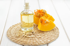 Pumpkin-Seed-Oil with cut pumpkin next it