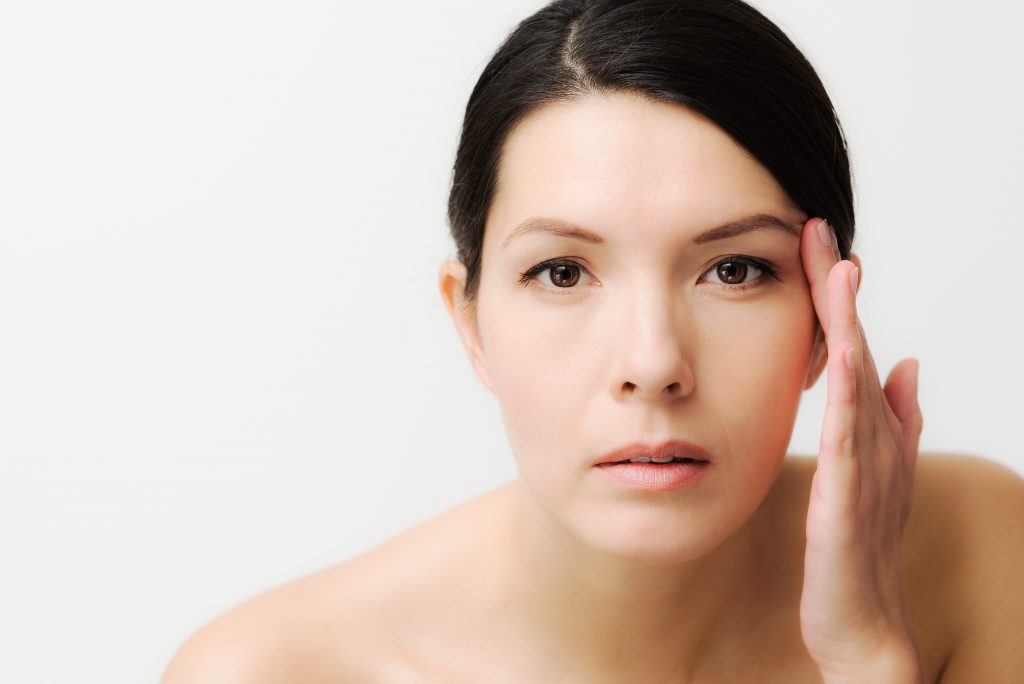 Woman checking for signs of aging