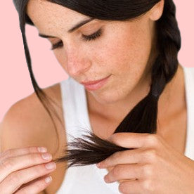 woman checking for split ends