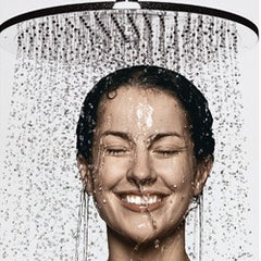 Woman under big shower head