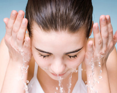 Woman rinsing face