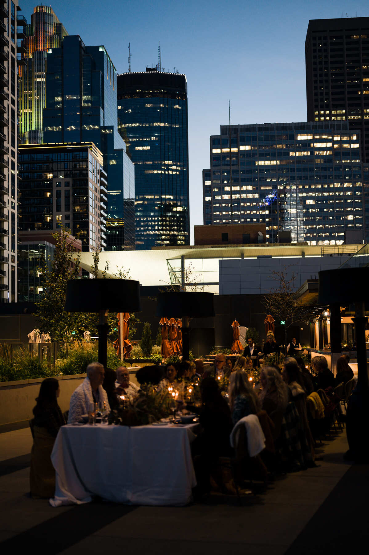 outdoor terrace at dinner time with skyscrapers in background