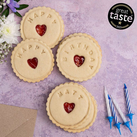 The Biskery's Signature jam biscuits to celebrate happy birthday against a pink backdrop