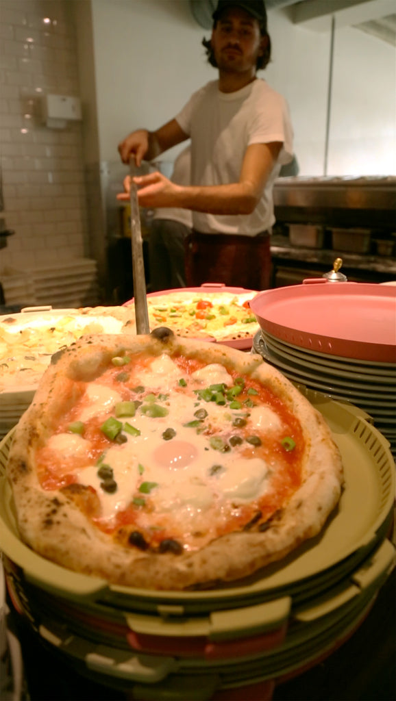 Pizzaiolo at L.A. Signorina in Stuttgart is putting a pizza in PIZZycle