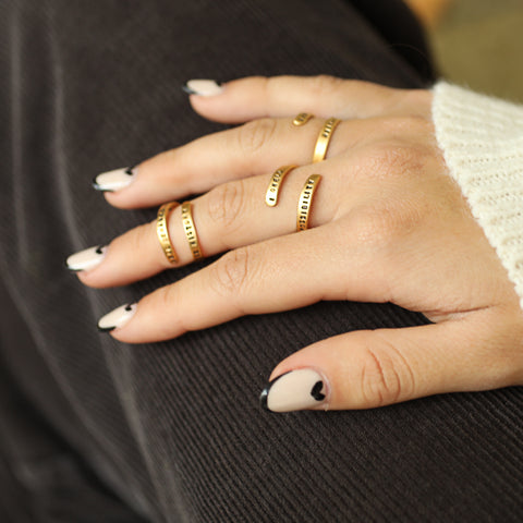 hand with 3 rings on different fingers