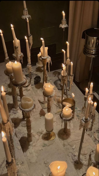 lots of taper candles on a table