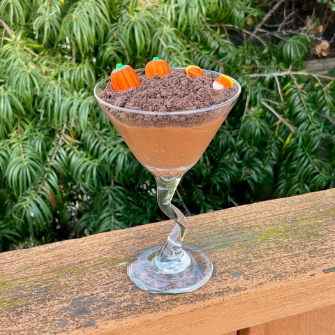 dirt pudding in a martini glass with pumpkin candy corn on top