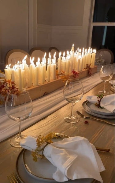 a lot of taper candles on a table
