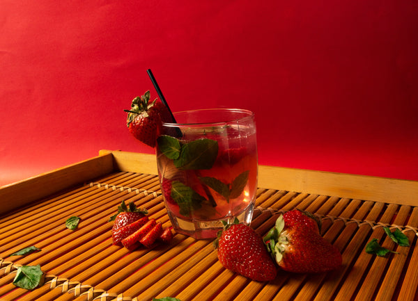 Cocktail in a glass with ice and strawberries