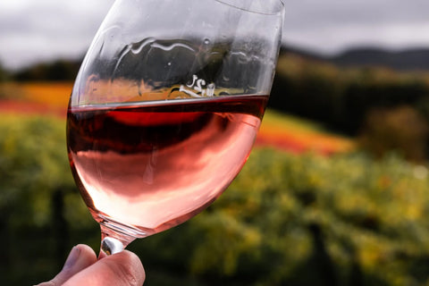 Rose-colored wine inside of wine glass