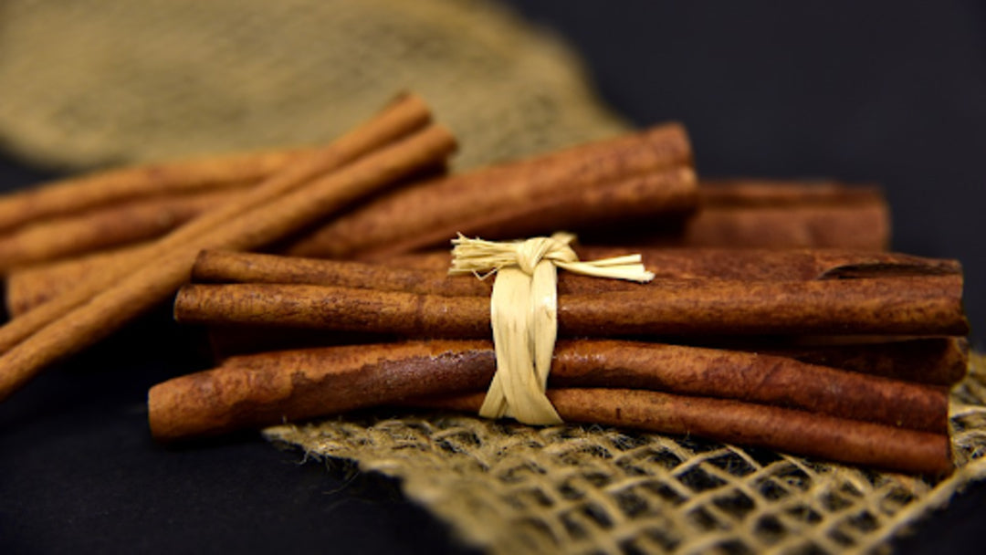 a bundle of cinnamon sticks tied with a white wrap 