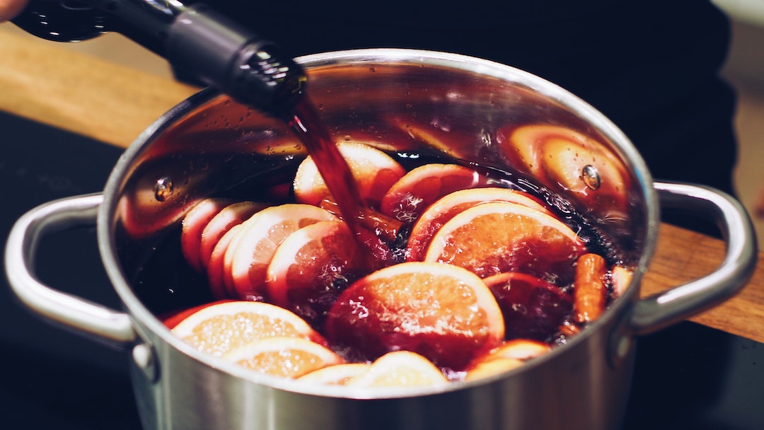 wine being poured into a pot or sliced oranges
