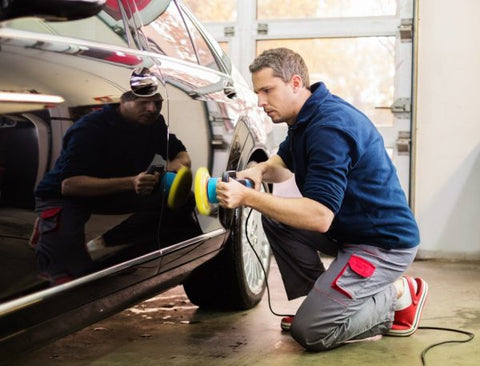 man with car polisher 