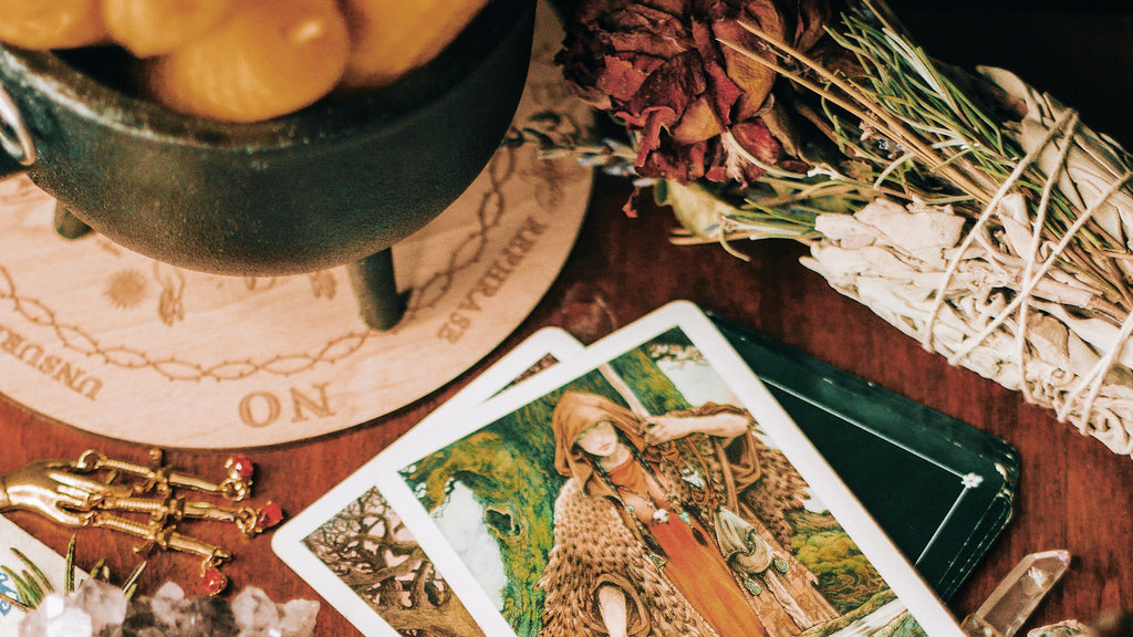The tarot cards are laid out and depict rich, evocative illustrations, which may imply a connection between the imagery on the cards and the natural elements used in rituals, possibly highlighting a holistic approach to understanding reversals in tarot.