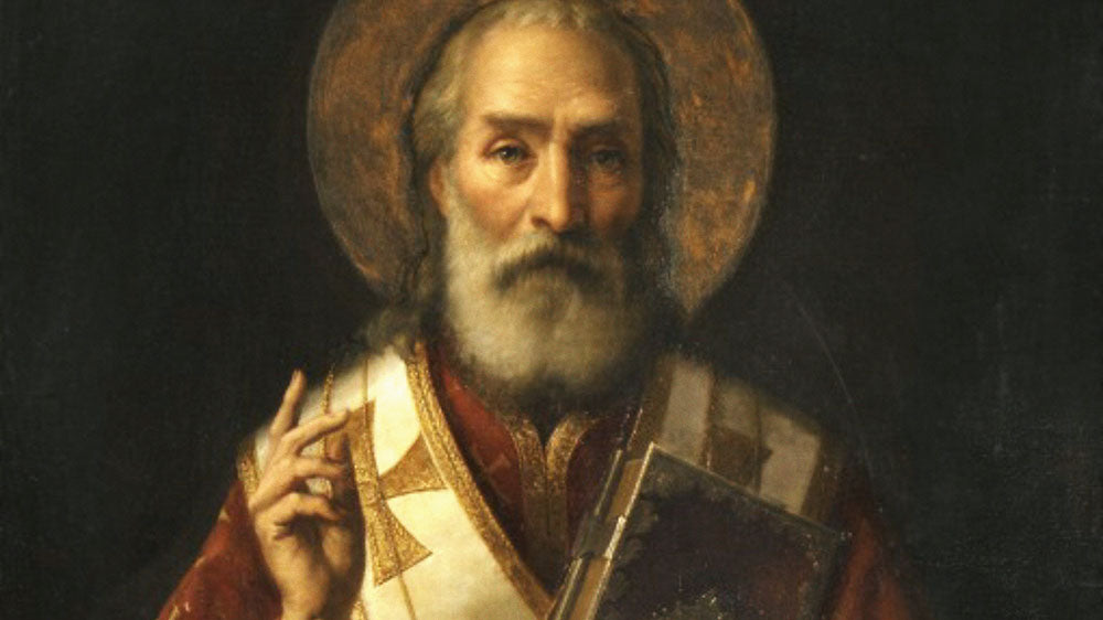 This is a classic painting depicting a saintly figure with a long white beard, wearing red and white clerical robes with intricate gold trim, and a halo around his head. He is holding a cross in one hand while the other is raised in a gesture of blessing.