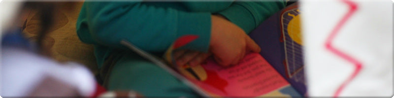 child reading book in teepee