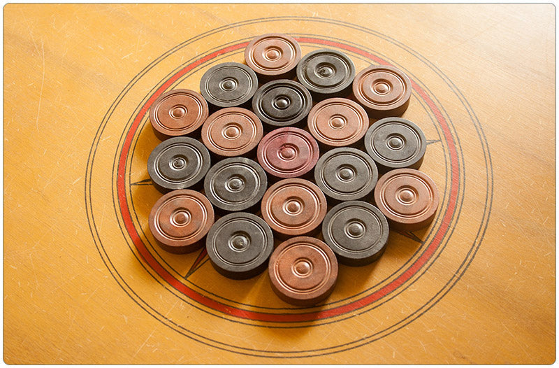 Showing how to lay out the carrom men when setting up your game