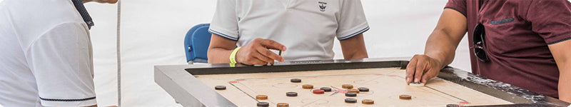 People playing a game of carrom