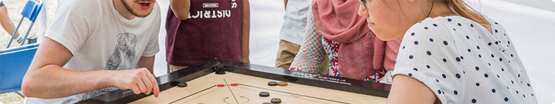 A couple playing carrom together