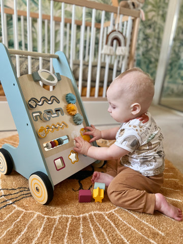 Baby playing with FSC® Certified push along walker