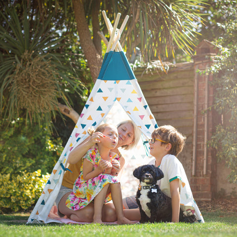 Family playing in Wooden Teepee