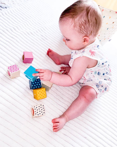 Baby playing with Sensory Blocks toy