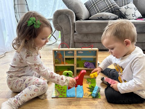 Toddlers playing with Dinosaur Playbox together