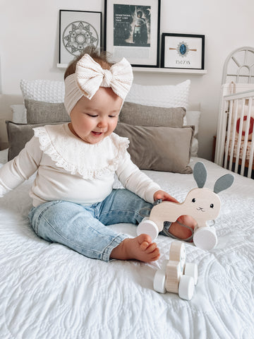 Easter toys: baby playing with Pull Along Bunny