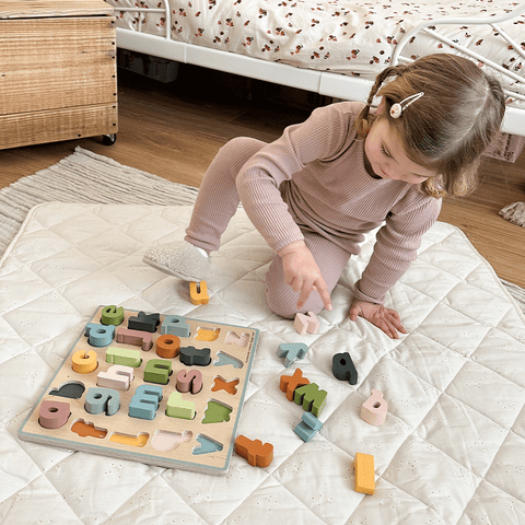 Girl playing with language learning alphabet puzzle