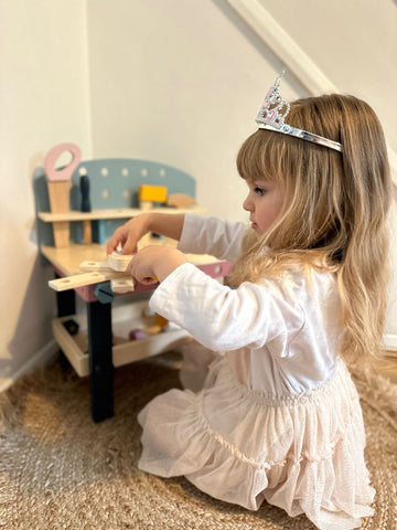 Girl playing with Wooden Tool Bench