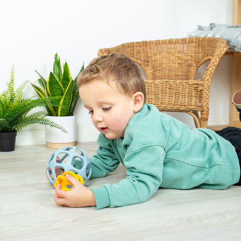 Boy playing with silicone Activity Balls 