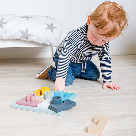 Toddler playing with Mosaic Puzzle silicone toy
