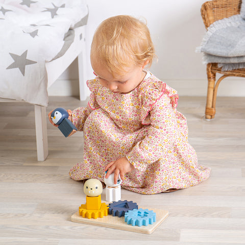 Girl playing with silicone toys (Arctic Cog Puzzle)