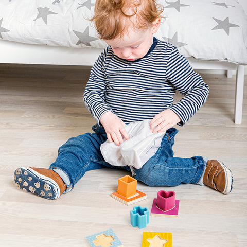 Child playing with Feel & Find wood & silicone toy