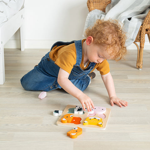 Easter toys: boy playing with Woodland Counting Puzzle
