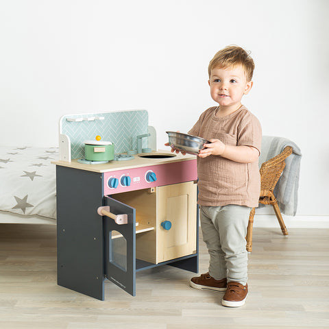 Boy playing with Simply Scandi Toy Kitchen