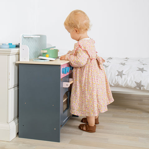 Girl playing in imaginative play kitchen