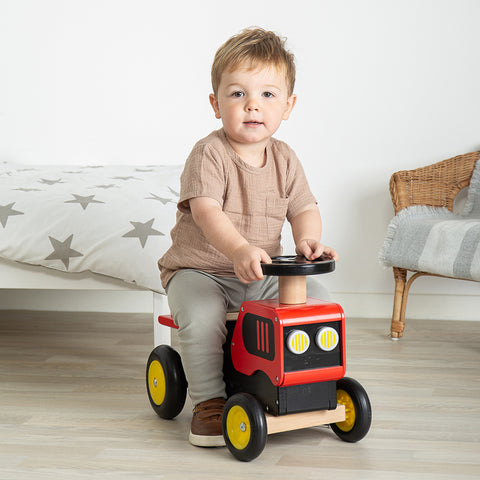 Boy playing on the Ride On Tractor Christmas gift