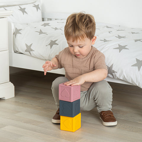 Easter toys: boy playing with Silicone Sensory Cubes