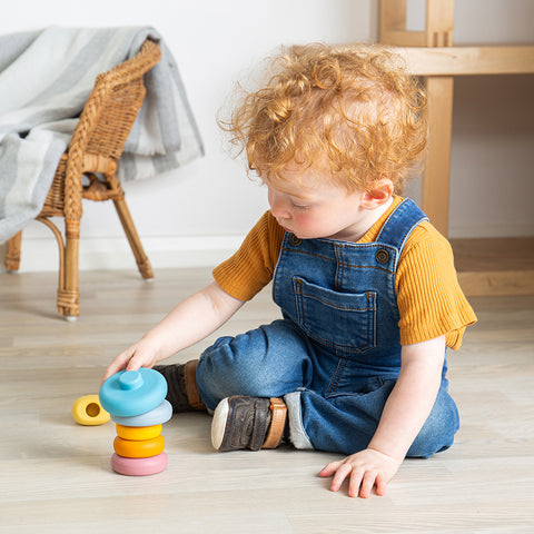 Boy playing with Stacking Cat baby toy