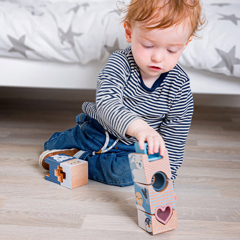 1 year old playing with a wooden sensory puzzle
