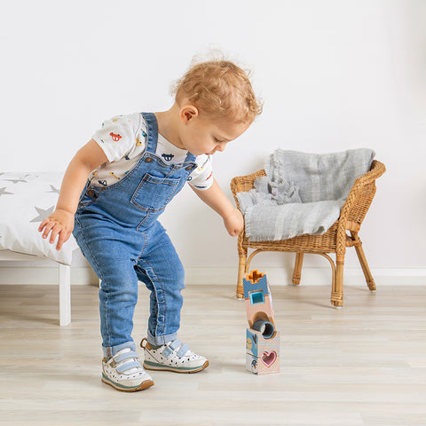 Toddler playing with Arctic Tower Puzzle wood & silicone toy