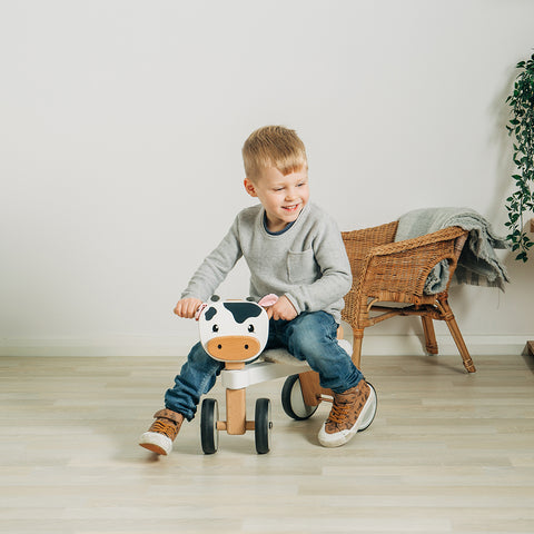Boy playing pretend on a Ride On Cow toy