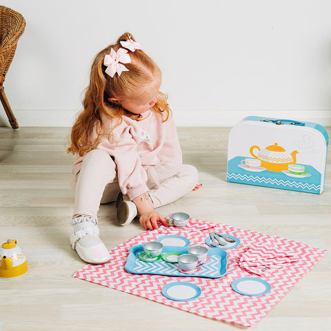 Girl playing with Tin Tea Set